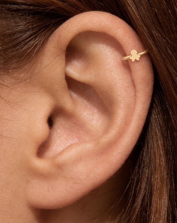 This stylised miniature octopus has a large rounded head and four short arm shapes extending around the lower edge. Its smooth, polished surface has no engraved eyes, sucker details or gemstones, keeping the silhouette clear and minimal.

Handmade to order in nickel-free 14ct solid gold, this octopus helix hoop is available in yellow, white or rose gold. Choose a 5, 6 or 7mm internal diameter and 18G (1.0mm) or 20G (0.8mm). The motif measures approximately 3mm. Designed for fully healed helix piercings, wit