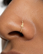 Keep a favourite animal close. This 14ct solid gold cat nostril ring pairs an approximately 3mm polished sitting-cat silhouette with a smooth seamless hoop. Pointed ears, a softly rounded body and an upright curved tail give the little cat its character.
Handmade to order in yellow, white or rose gold, with inner diameters from 6 to 10mm and a choice of 18G (1.0mm) or 20G (0.8mm). Both the cat and hoop are solid gold and nickel-free, designed for a fully healed nostril piercing.
Wear it alone for one playfu