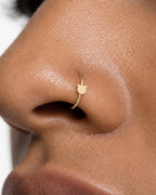 Two round ears, one familiar little face. This 14ct solid gold bear nostril ring pairs an approximately 3mm polished bear-head silhouette with a smooth seamless hoop. Its rounded outline gives the design a playful teddy-bear feel, with no engraved facial features or gemstones.
Handmade to order in yellow, white or rose gold, with inner diameters from 6 to 10mm and a choice of 18G (1.0mm) or 20G (0.8mm). Both the bear motif and hoop are solid gold and nickel-free, designed for a fully healed nostril piercing