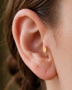 A polished oval adds a softer geometric detail for a clean, understated look. Made for fully healed tragus piercings, it adds a compact decorative detail without turning the piece into a dangling design. Handmade to order in 14ct solid gold, it fits naturally with softly geometric and minimal styling rather than reading as a generic plain hoop.