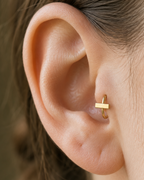 A slim bar creates a clean linear accent for a more modern, pared-back jewellery stack. Made for fully healed tragus piercings, it adds a compact decorative detail without turning the piece into a dangling design. Handmade to order in 14ct solid gold, it fits naturally with linear, minimal and modern styling rather than reading as a generic plain hoop.
