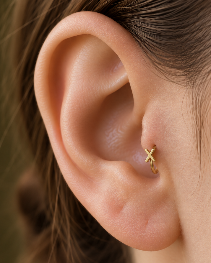 Choose two letters for a compact personalised motif that can represent initials without becoming oversized. Made for fully healed tragus piercings, it adds a compact decorative detail without turning the piece into a dangling design. Handmade to order in 14ct solid gold, it fits naturally with personalised, meaningful and monogram-led styling rather than reading as a generic plain hoop.