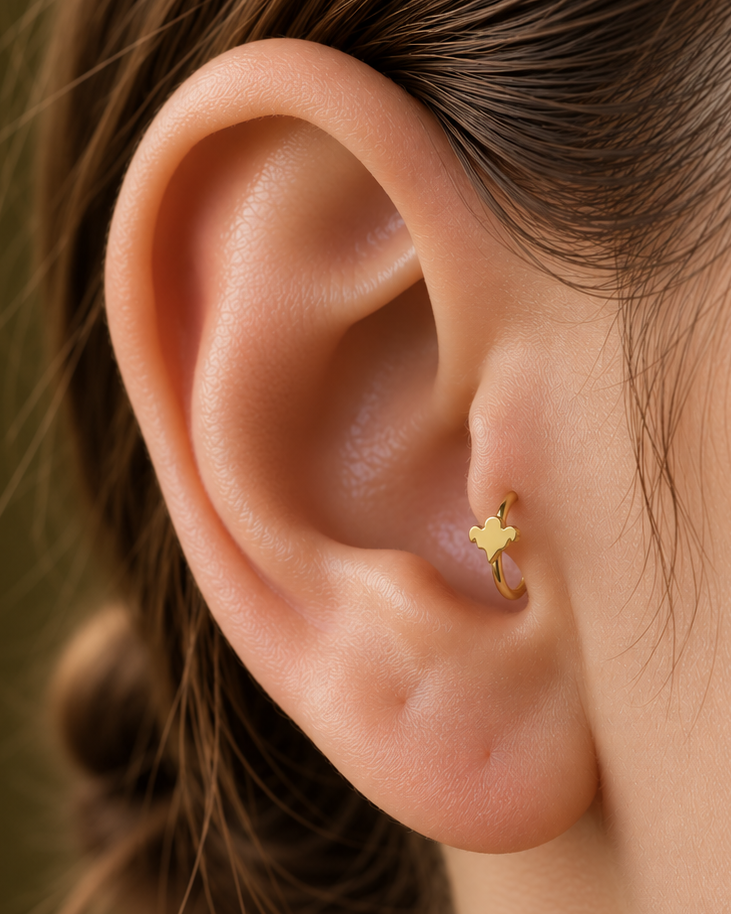 A small ghost motif adds a light spooky-season accent that still works as fine solid-gold jewellery. Made for fully healed tragus piercings, it adds a compact decorative detail without turning the piece into a dangling design. Handmade to order in 14ct solid gold, it fits naturally with spooky, playful and seasonal styling rather than reading as a generic plain hoop.