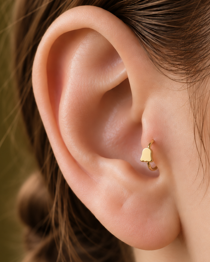 A softer cute-ghost motif keeps the Halloween reference playful rather than dark or heavy. Made for fully healed tragus piercings, it adds a compact decorative detail without turning the piece into a dangling design. Handmade to order in 14ct solid gold, it fits naturally with cute, playful and Halloween-led styling rather than reading as a generic plain hoop.