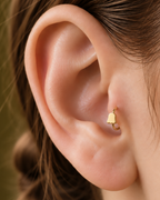 A softer cute-ghost motif keeps the Halloween reference playful rather than dark or heavy. Made for fully healed tragus piercings, it adds a compact decorative detail without turning the piece into a dangling design. Handmade to order in 14ct solid gold, it fits naturally with cute, playful and Halloween-led styling rather than reading as a generic plain hoop.