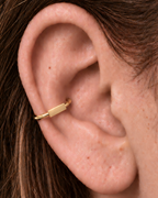 A slim bar creates a clean linear accent for a more modern, pared-back jewellery stack. Made for fully healed conch piercings, it pairs the larger hoop silhouette of a conch ring with a small fixed motif for a more distinctive ear stack. Handmade to order in 14ct solid gold, it fits naturally with linear, minimal and modern styling rather than reading as a generic plain hoop.