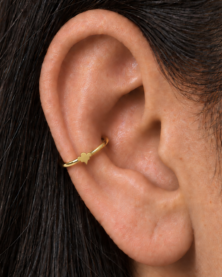 A small ghost motif adds a light spooky-season accent that still works as fine solid-gold jewellery. Made for fully healed conch piercings, it pairs the larger hoop silhouette of a conch ring with a small fixed motif for a more distinctive ear stack. Handmade to order in 14ct solid gold, it fits naturally with spooky, playful and seasonal styling rather than reading as a generic plain hoop.