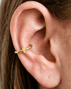 A small coffin motif gives the hoop a compact gothic accent with a clean polished finish. Made for fully healed conch piercings, it pairs the larger hoop silhouette of a conch ring with a small fixed motif for a more distinctive ear stack. Handmade to order in 14ct solid gold, it fits naturally with gothic, alternative and Halloween-led styling rather than reading as a generic plain hoop.