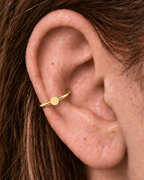 A simple circle motif keeps the design pared back, rounded and easy to mix with other jewellery. Made for fully healed conch piercings, it pairs the larger hoop silhouette of a conch ring with a small fixed motif for a more distinctive ear stack. Handmade to order in 14ct solid gold, it fits naturally with simple, rounded and minimal styling rather than reading as a generic plain hoop.