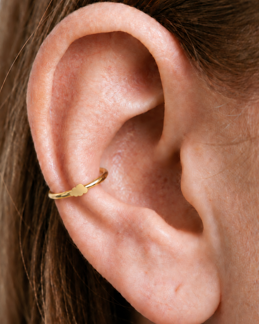 A softly rounded cloud adds a playful sky-inspired detail while keeping the scale small. Made for fully healed conch piercings, it pairs the larger hoop silhouette of a conch ring with a small fixed motif for a more distinctive ear stack. Handmade to order in 14ct solid gold, it fits naturally with soft, playful and sky-inspired styling rather than reading as a generic plain hoop.