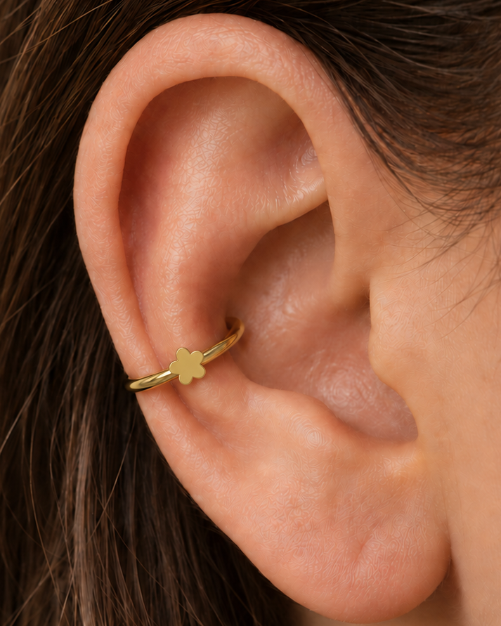 A tiny flower brings a light botanical accent without making the jewellery feel busy. Made for fully healed conch piercings, it pairs the larger hoop silhouette of a conch ring with a small fixed motif for a more distinctive ear stack. Handmade to order in 14ct solid gold, it fits naturally with floral, botanical and nature-inspired styling rather than reading as a generic plain hoop.