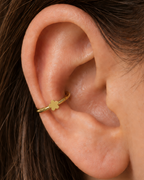 A tiny flower brings a light botanical accent without making the jewellery feel busy. Made for fully healed conch piercings, it pairs the larger hoop silhouette of a conch ring with a small fixed motif for a more distinctive ear stack. Handmade to order in 14ct solid gold, it fits naturally with floral, botanical and nature-inspired styling rather than reading as a generic plain hoop.