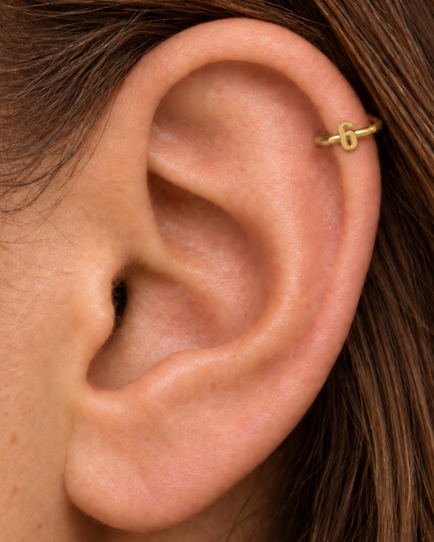 Choose one digit to give the hoop a small number-led detail with personal meaning. Made for fully healed helix piercings, it keeps the profile compact for an upper-ear stack while leaving the motif clearly visible. Handmade to order in 14ct solid gold, it fits naturally with personalised, number-led and meaningful styling rather than reading as a generic plain hoop.