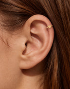 This miniature bear head has two rounded ears and a smooth, gently curved face. Its polished surface has no engraved eyes or nose and no gemstones, keeping the outline clear and minimal.

Handmade to order in nickel-free 14ct solid gold, this bear helix hoop is available in yellow, white or rose gold. Choose a 5, 6 or 7mm internal diameter and 18G (1.0mm) or 20G (0.8mm). The motif measures approximately 3mm. Designed for fully healed helix piercings, with sizing chosen to suit your piercing position and ear