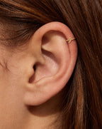 This miniature candy cane has a curved hook at the top and a straight stem with a rounded end. Its smooth gold surface has no engraved stripes, coloured enamel or gemstones, keeping the Christmas sweet-inspired outline clear and minimal.

Handmade to order in nickel-free 14ct solid gold, this candy cane helix hoop is available in yellow, white or rose gold. Choose a 5, 6 or 7mm internal diameter and 18G (1.0mm) or 20G (0.8mm). The motif measures approximately 3mm. Designed for fully healed helix piercings, 