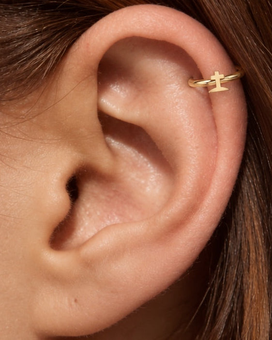 A graveyard-style cross gives the hoop a darker gothic reference that is distinct from the simpler cross design. Made for fully healed helix piercings, it keeps the profile compact for an upper-ear stack while leaving the motif clearly visible. Handmade to order in 14ct solid gold, it fits naturally with gothic, spooky and alternative styling rather than reading as a generic plain hoop.