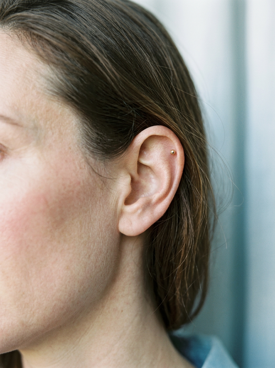 Editorial ear image marking Helix and Tragus positions for a motif hoop direction guide