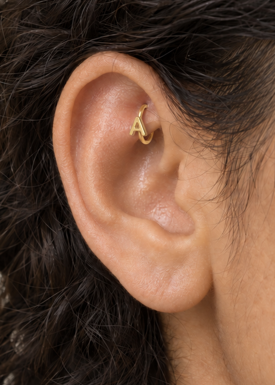 Choose two letters for a compact personalised motif that can represent initials without becoming oversized. Made for fully healed traditional rook piercings, it gives a small curved ear placement a clear motif-led detail while keeping the hoop clean and wearable. Handmade to order in 14ct solid gold, it fits naturally with personalised, meaningful and monogram-led styling rather than reading as a generic plain hoop.