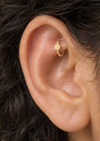 A simple circle motif keeps the design pared back, rounded and easy to mix with other jewellery. Made for fully healed traditional rook piercings, it gives a small curved ear placement a clear motif-led detail while keeping the hoop clean and wearable. Handmade to order in 14ct solid gold, it fits naturally with simple, rounded and minimal styling rather than reading as a generic plain hoop.