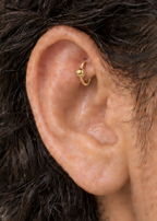 A polished ball adds a classic bead-like detail that works easily with simple solid-gold jewellery. Made for fully healed traditional rook piercings, it gives a small curved ear placement a clear motif-led detail while keeping the hoop clean and wearable. Handmade to order in 14ct solid gold, it fits naturally with classic, polished and minimal styling rather than reading as a generic plain hoop.