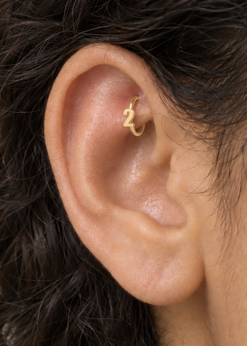 Choose one digit to give the hoop a small number-led detail with personal meaning. Made for fully healed traditional rook piercings, it gives a small curved ear placement a clear motif-led detail while keeping the hoop clean and wearable. Handmade to order in 14ct solid gold, it fits naturally with personalised, number-led and meaningful styling rather than reading as a generic plain hoop.