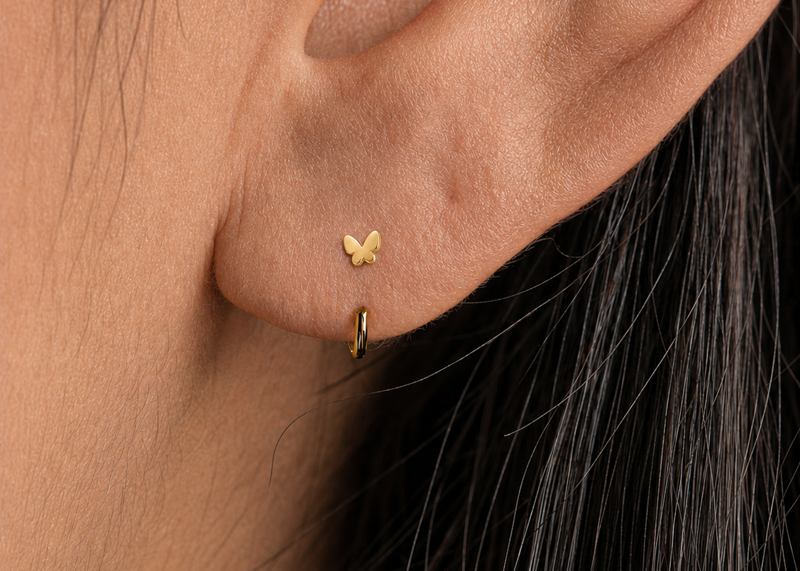 A delicate 14ct solid gold butterfly on an easy-to-wear open hoop — light, meaningful and made for everyday styling.