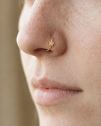 A delicate butterfly detail for your everyday jewellery. This 14ct solid gold butterfly nostril ring pairs an approximately 3mm polished butterfly silhouette with a smooth seamless hoop. Larger upper wings and smaller rounded lower wings create a soft, simple outline, with no gemstones or engraved decoration.
Handmade to order in yellow, white or rose gold, with inner diameters from 6 to 10mm and a choice of 18G (1.0mm) or 20G (0.8mm). Both the butterfly and hoop are solid gold and nickel-free, designed for