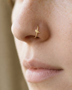 A little bird for your everyday jewellery. This 14ct solid gold bird nostril ring pairs an approximately 3mm polished bird silhouette with a smooth seamless hoop. A rounded head and breast, small pointed beak and tapered tail define the design, with no engraved feather pattern or gemstones.
Handmade to order in yellow, white or rose gold, with inner diameters from 6 to 10mm and a choice of 18G (1.0mm) or 20G (0.8mm). Both the bird and hoop are solid gold and nickel-free, designed for a fully healed nostril 